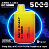 Bright yellow-to-red gradient rectangular disposable vape labeled "Bang Blaze BC 5000" and "Strawberry Mango" centered against a dark smoky background with a glowing blue ring, large "5000 PUFFS" text and small product specs at the bottom.