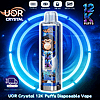 Transparent disposable vape pen branded UOR Crystal, featuring 12K Puffs Mr Blue, set against a neon backdrop.