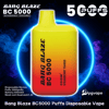 Bright yellow-to-red gradient rectangular disposable vape labeled "Bang Blaze BC 5000" and "Strawberry Mango" centered against a dark smoky background with a glowing blue ring, large "5000 PUFFS" text and small product specs at the bottom.