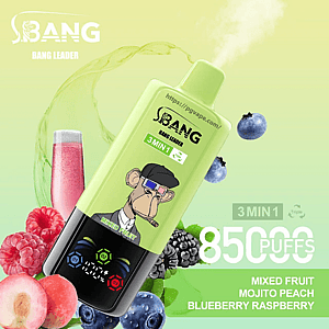 Light green disposable vape device labeled BANG Bang Leader with a cartoon ape wearing 3D glasses and a puff of vapor, tilted over raspberries, blueberries, blackberries, a peach and a pink drink, with on-image text advertising 3 in 1, 85,000 puffs and flavors Mixed Fruit, Mojito, Peach, Blueberry Raspberry.