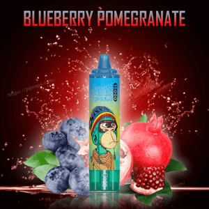 Disposable vape device with a cartoon monkey on a blue-green body labeled 'Tornado' centered between a cluster of blueberries and a halved pomegranate against a red splashing background with the title 'Blueberry Pomegranate' at the top.