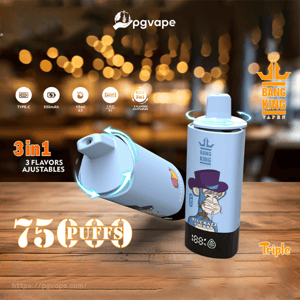 Two light-blue Bang King Vapen disposable vape devices—one upright showing a cartoon top-hatted monkey label and one tilted—resting on a wooden table with warm bokeh lights in the background, annotated with rotating arrows, '3 in 1' and large '75 puffs' text.