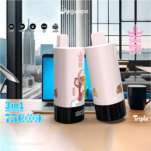 Two pastel-pink Bang King vape devices with black bases and fruit illustrations standing on a wooden desk in front of a laptop and city skyline, with visible '3 in 1' and '75 puffs' labels.