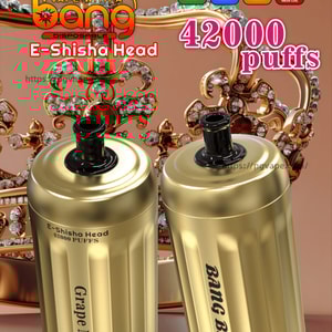 Two gold, can-shaped 'Bang Blaze' disposable e-shisha devices labeled 'Grape Mint' sit in front of a jeweled crown with bold text advertising 'Bang Blaze' and '42,000 puffs' and small icons for Type-C, 1000mAh, 30ml and 0.6Ω mesh coil.