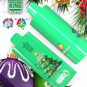 Two bright mint-green Bang King Vapen disposable devices with Christmas-tree and fruit icons displayed diagonally on a festive background of pine needles, holly berries and a purple ornament, accompanied by '100K Triple' and '3 in 1' graphics and small technical icons.
